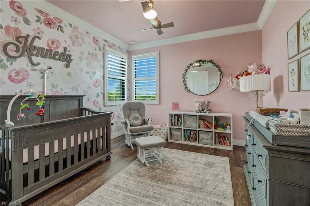4663 Azalea Drive Naples, FL 34119 - Photo 27 of 34 a living room with a baby crib furniture a chandelier and a window
