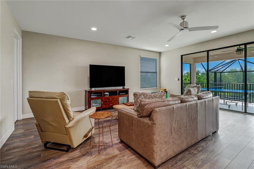 4663 Azalea Drive Naples, FL 34119 - Photo 28 of 34 a living room with furniture and a flat screen tv