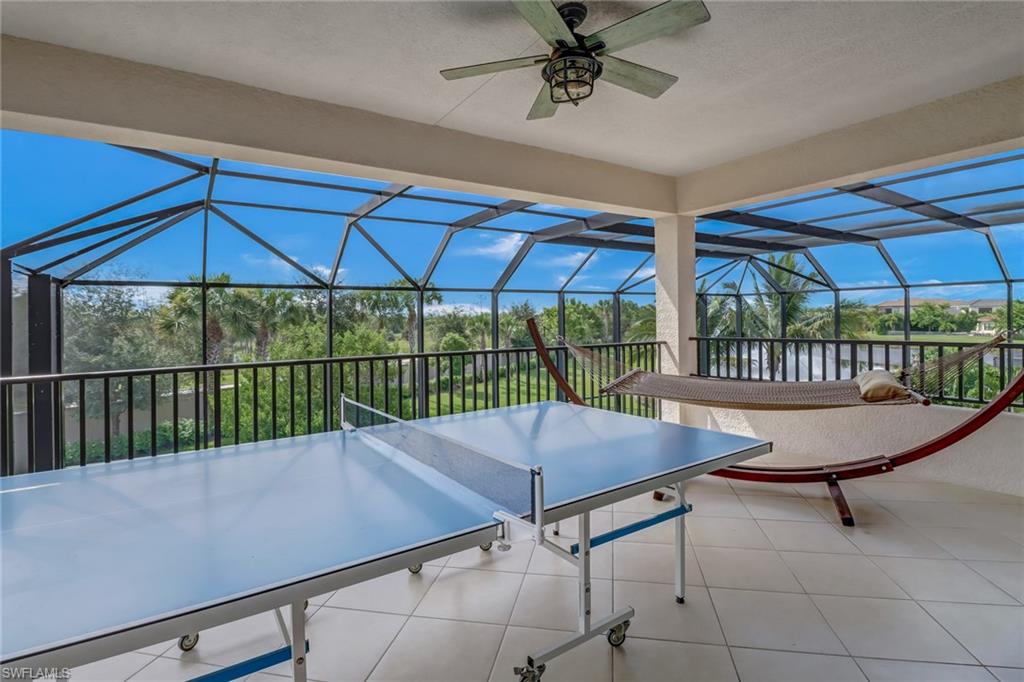 4663 Azalea Drive Naples, FL 34119 - Photo 33 of 34 a view of a patio with a table chairs and a umbrella
