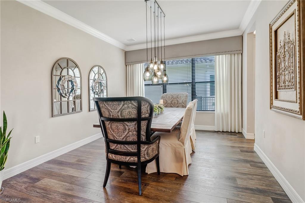 4663 Azalea Drive Naples, FL 34119 - Photo 8 of 34 a dining room with furniture a chandelier and wooden floor