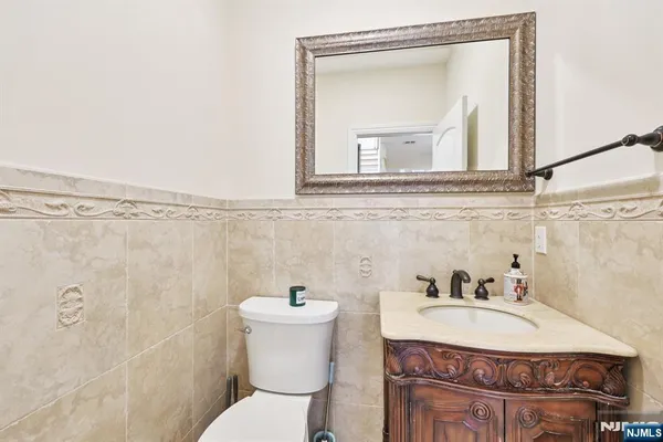 a bathroom with a sink a mirror and a toilet