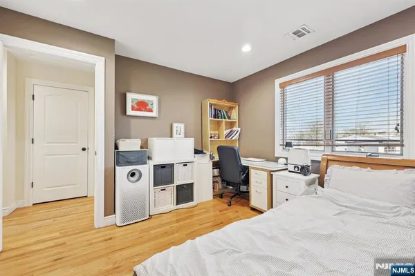 a bedroom with a bed and a large window