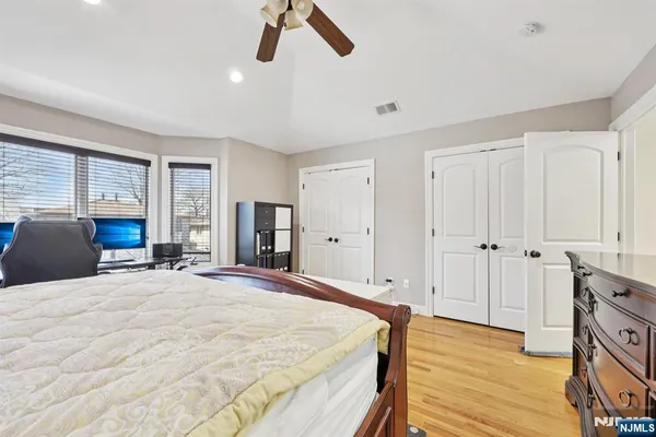 a spacious bedroom with a bed and a large window