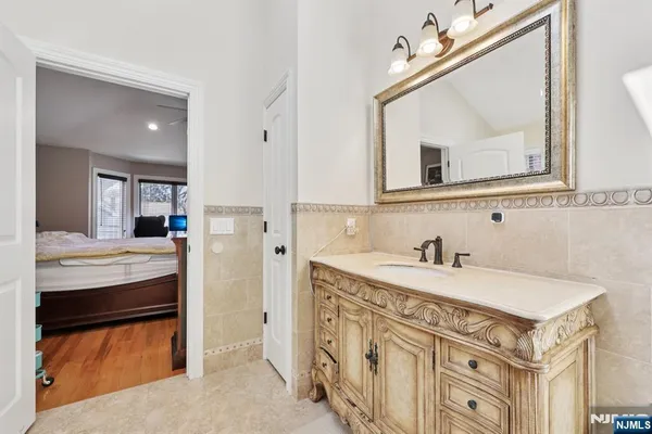a bathroom with a sink a vanity and a mirror