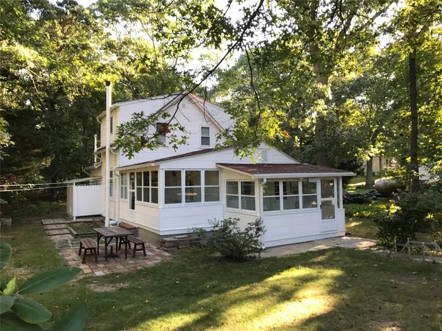 a view of a house with a yard balcony and sitting area