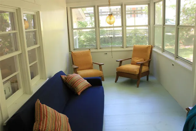 a living room with furniture and a floor to ceiling window