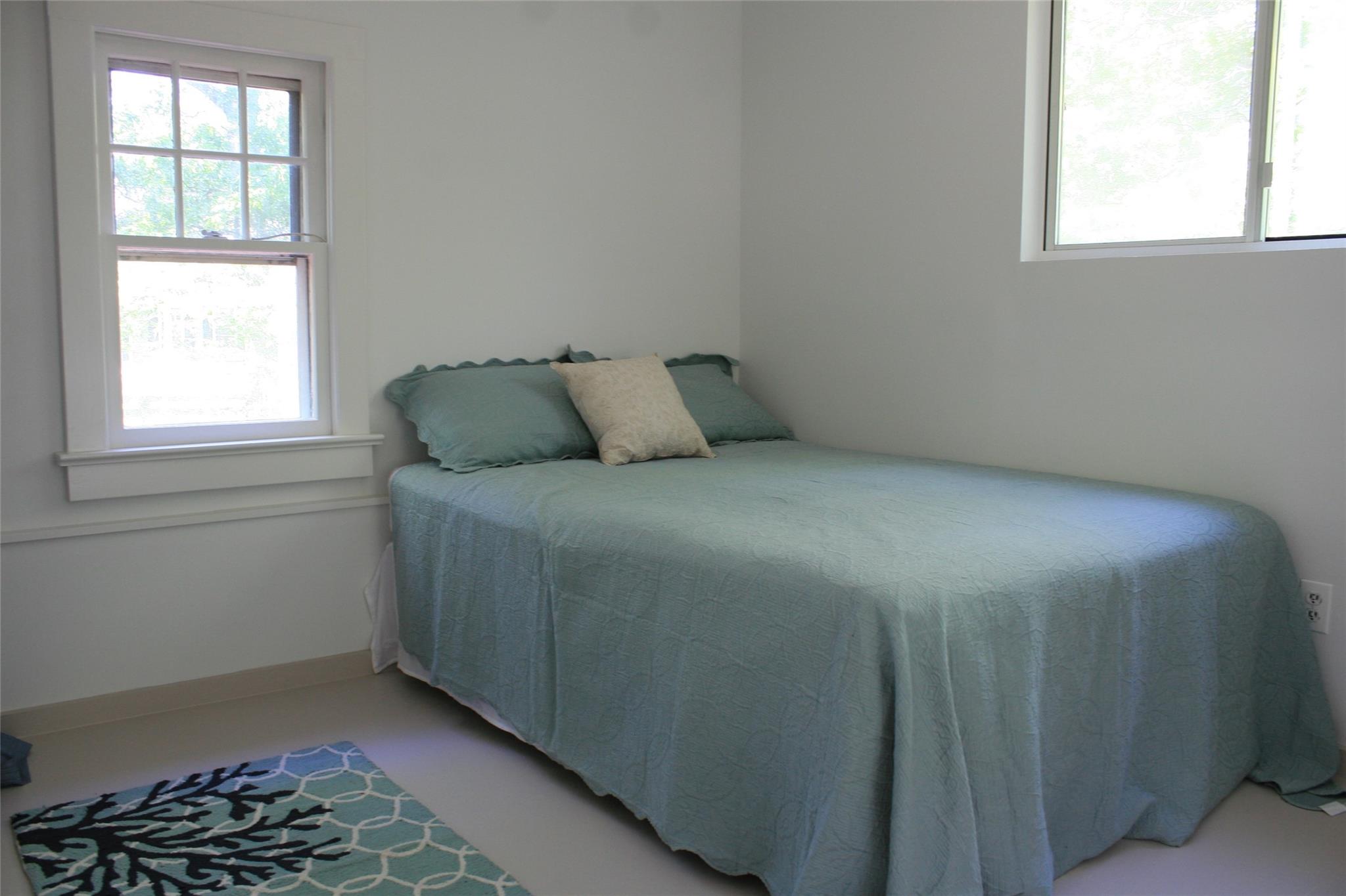 275 Hamilton Avenue Cutchogue, NY 11935 - Photo 8 of 17 a bed sitting in a bedroom next to a window