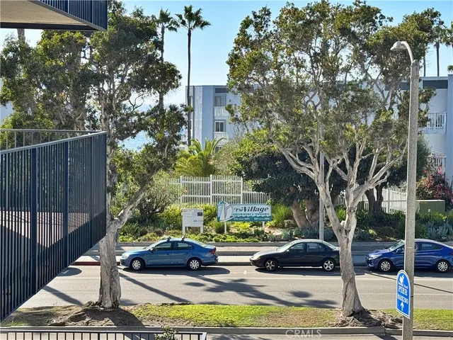 a view of a yard with plants and a barbeque