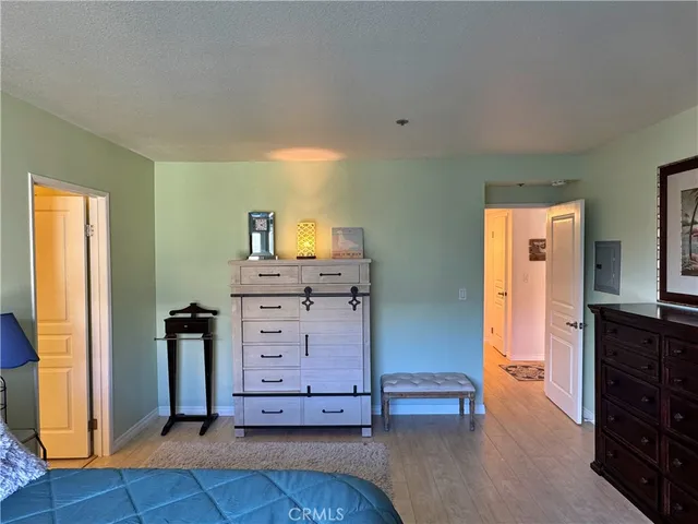 a view of a bedroom with furniture and window