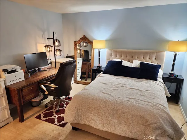 a bedroom with a bed a desk and chair