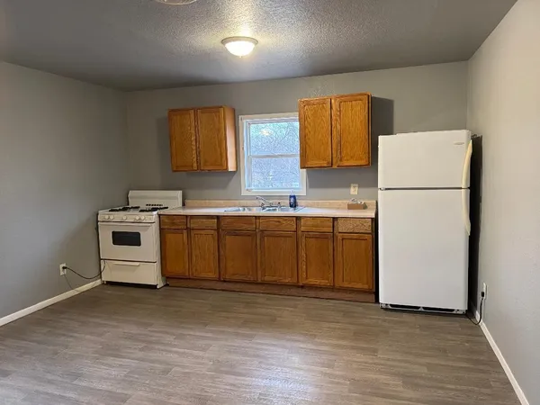 a kitchen with a white cabinets and white appliances