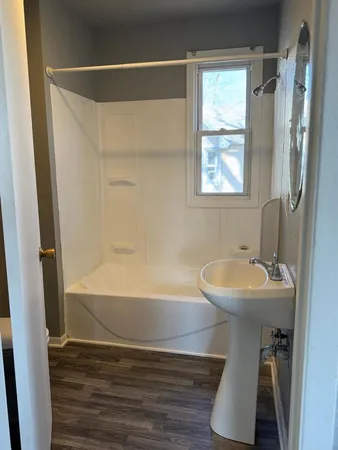 a bathroom with a sink a mirror and a bathtub