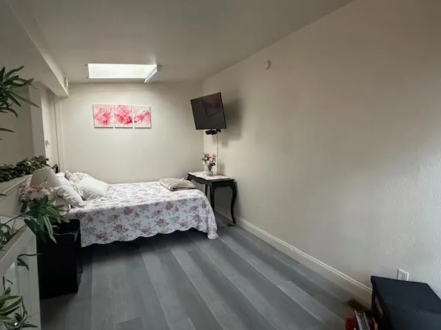 a bedroom with a bed and a flat screen tv