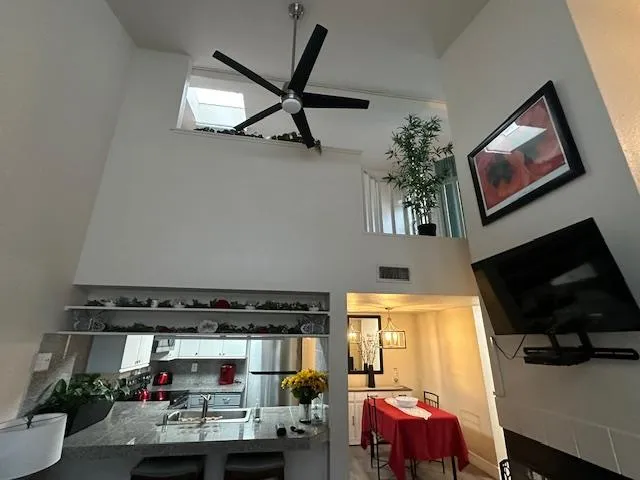 a view of a living room with furniture and a flat screen tv