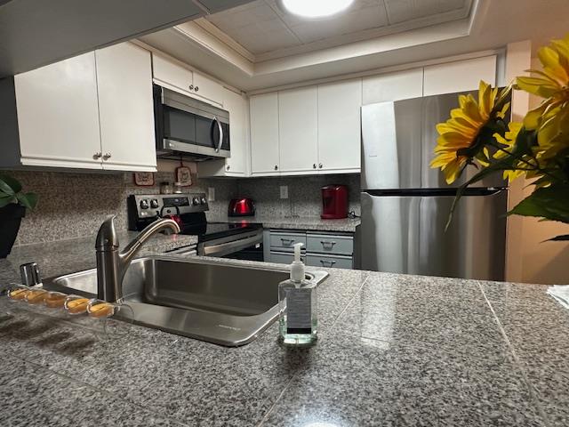 2511 Fulton Square Lane, Unit 9 Sacramento, CA 95821 - Photo 6 of 19 a kitchen with stainless steel appliances a refrigerator a stove a microwave a sink and cabinets