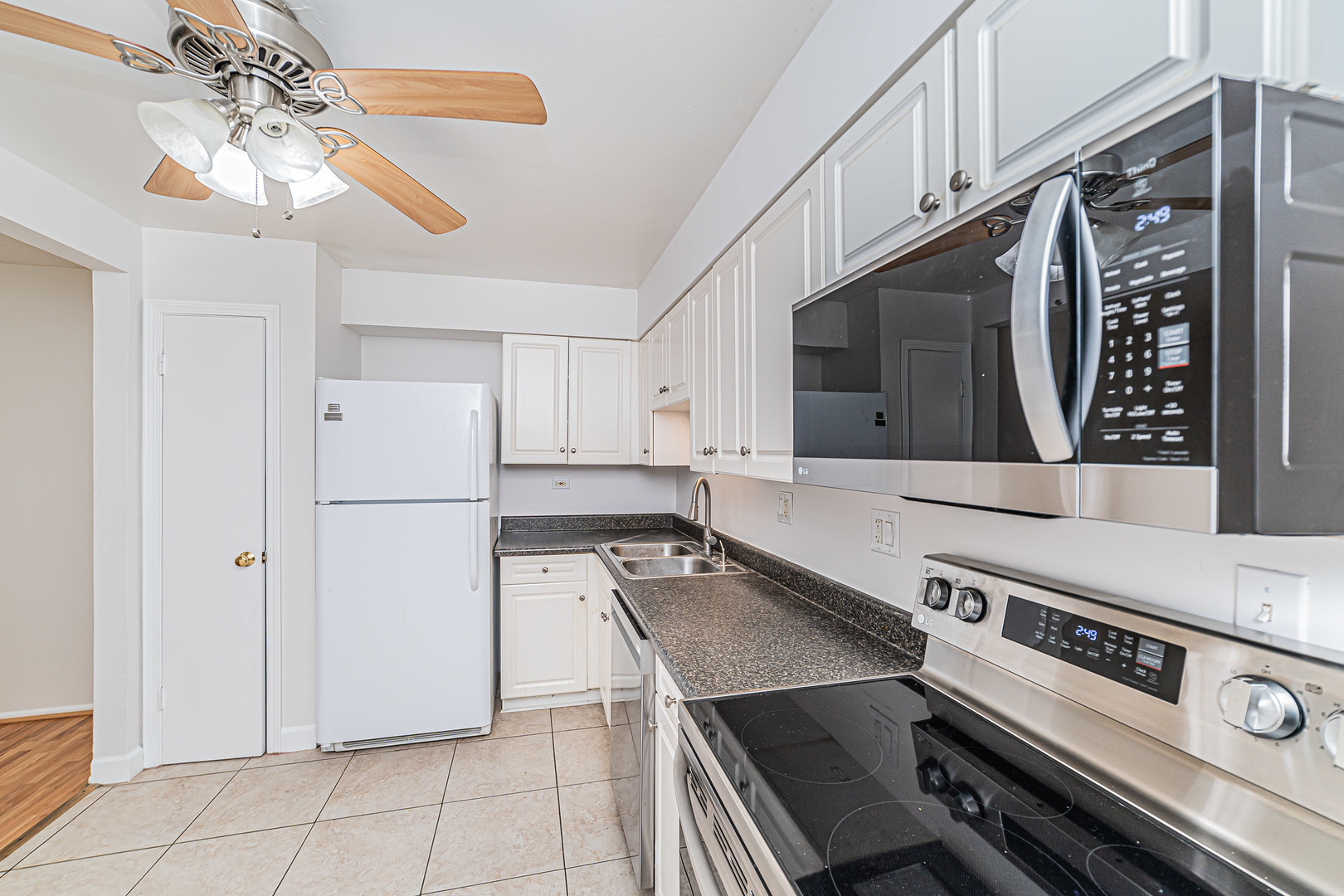 714 East Algonquin Road, Unit J101 Arlington Heights, IL 60005 - Photo 14 of 28 a kitchen with stainless steel appliances a stove a sink and a refrigerator