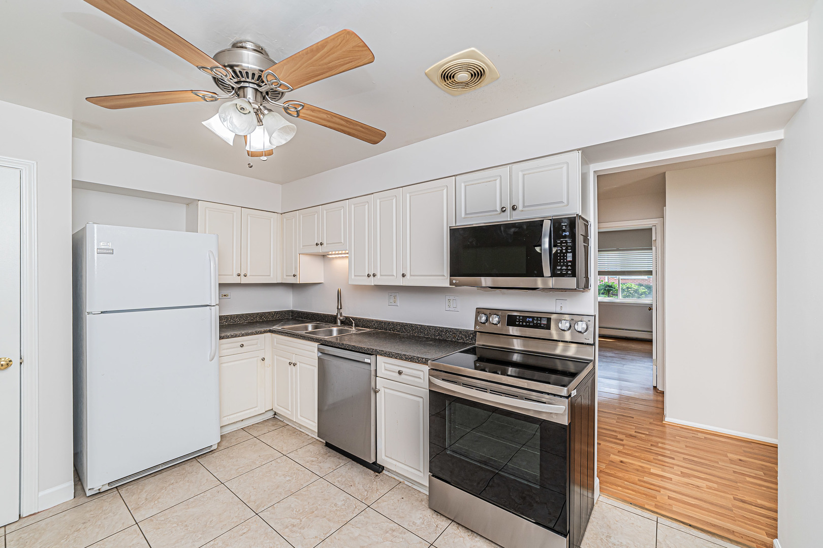 714 East Algonquin Road, Unit J101 Arlington Heights, IL 60005 - Photo 16 of 28 a kitchen with stainless steel appliances a stove microwave and a refrigerator