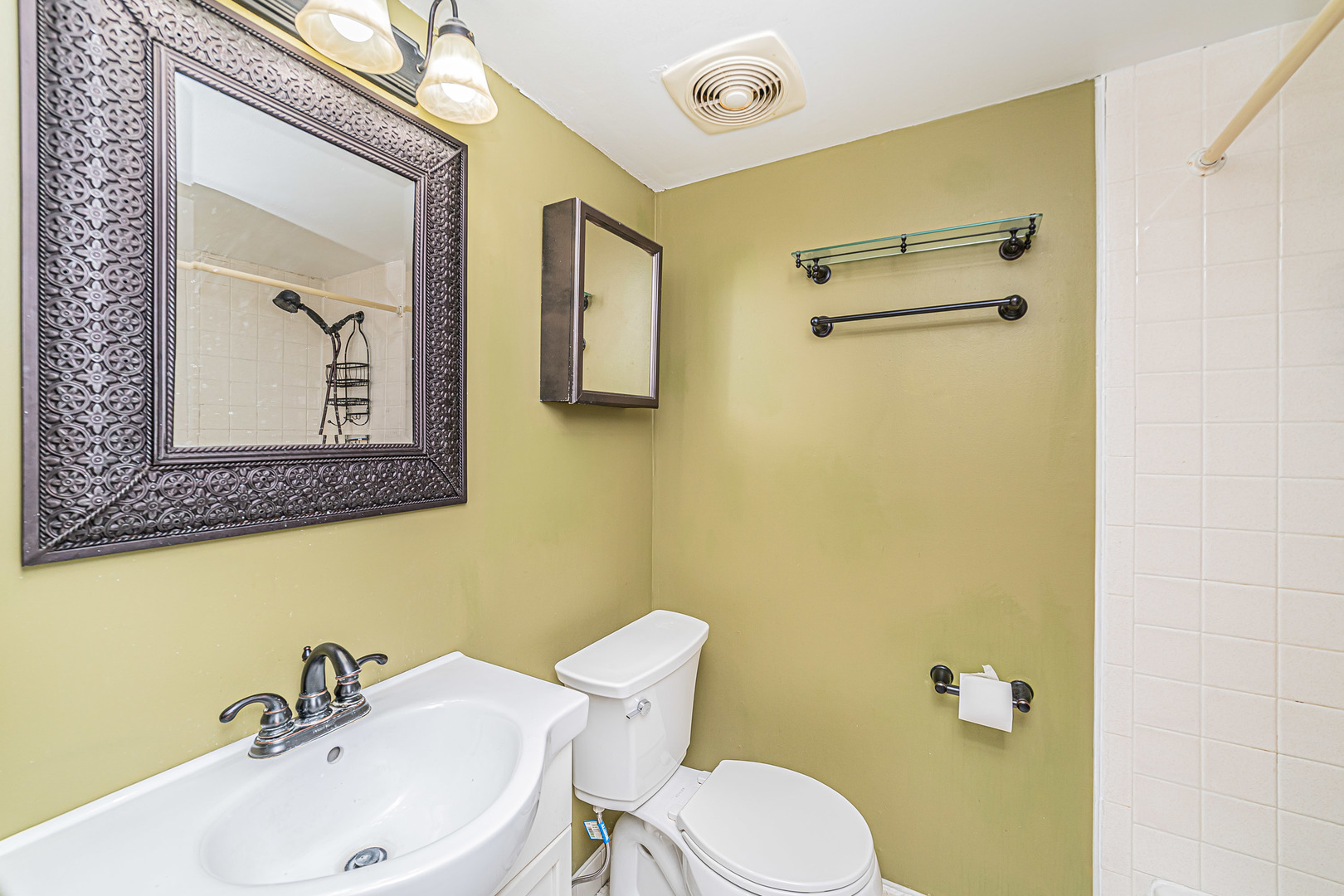 714 East Algonquin Road, Unit J101 Arlington Heights, IL 60005 - Photo 20 of 28 a bathroom with a toilet a sink and mirror