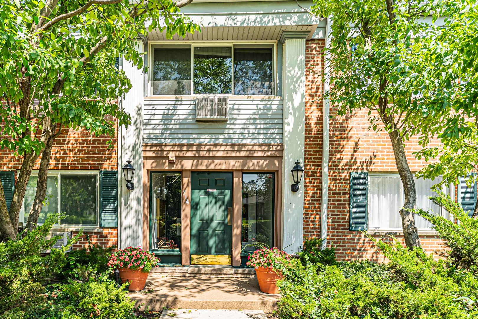 714 East Algonquin Road, Unit J101 Arlington Heights, IL 60005 - Photo 3 of 28 front view of a house with potted plants