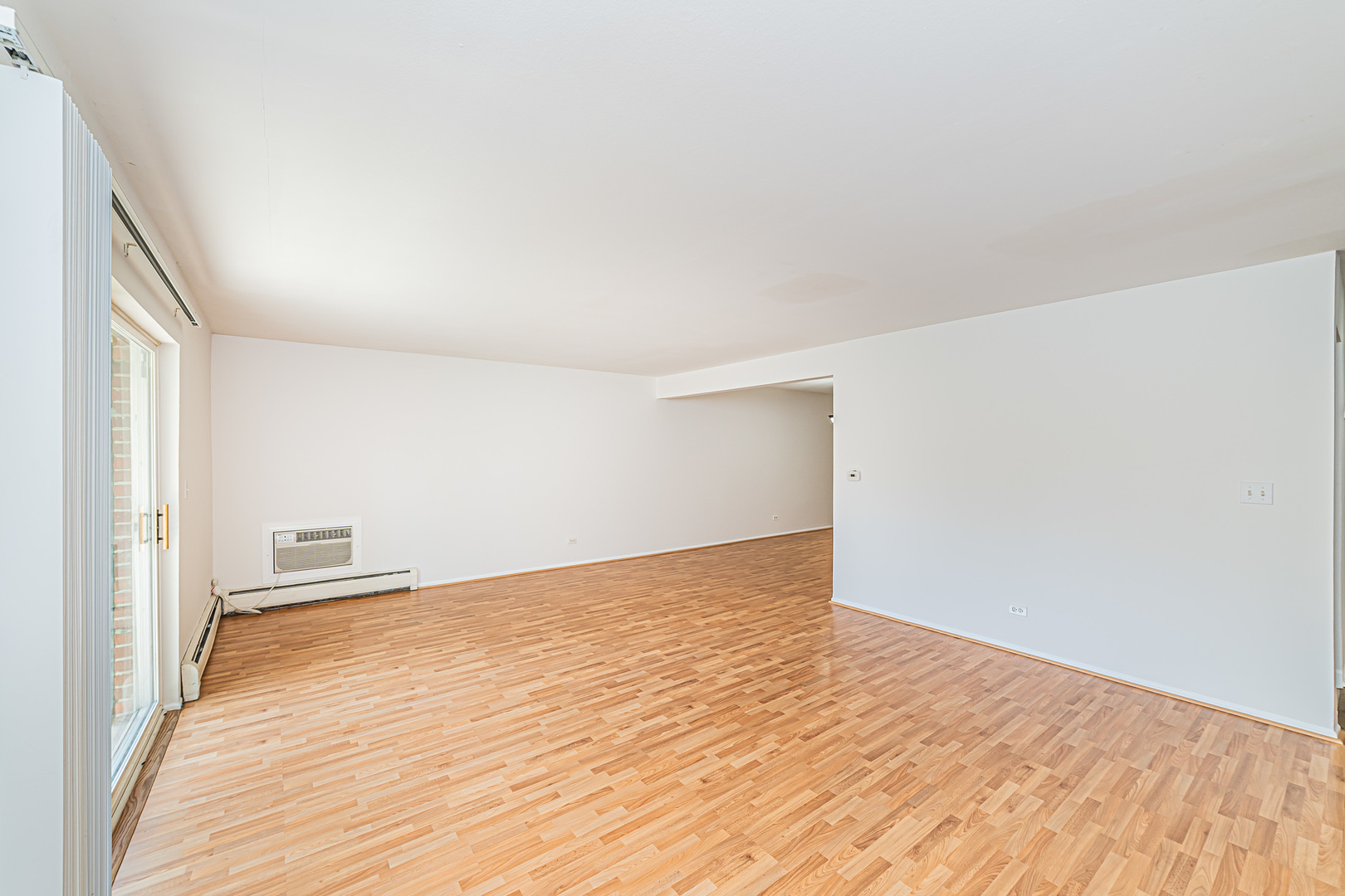 714 East Algonquin Road, Unit J101 Arlington Heights, IL 60005 - Photo 9 of 28 a view of an empty room and wooden floor