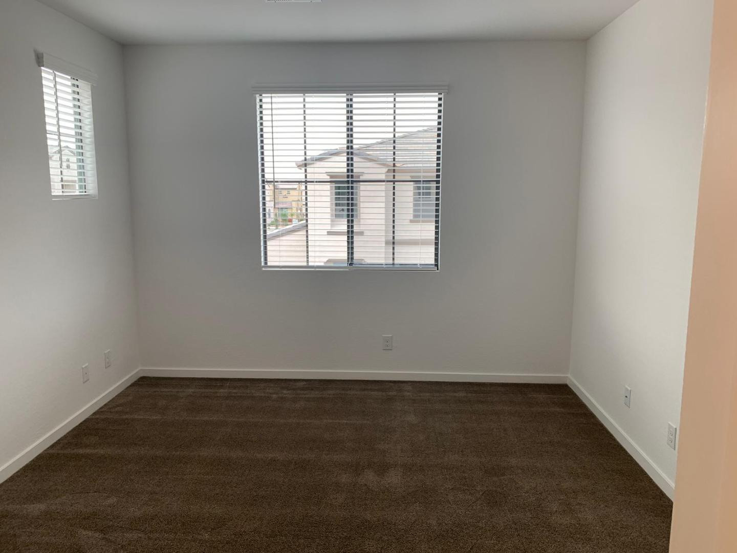 3900 East Baseline Road, Unit 118 Phoenix, AZ 85042 - Photo 24 of 32 an empty room with wooden floor and windows