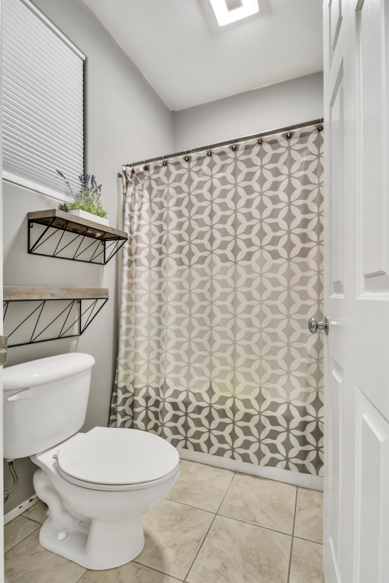 82949 Corte Lucia Indio, CA 92201 - Photo 12 of 36 a bathroom with a toilet and a shower curtain