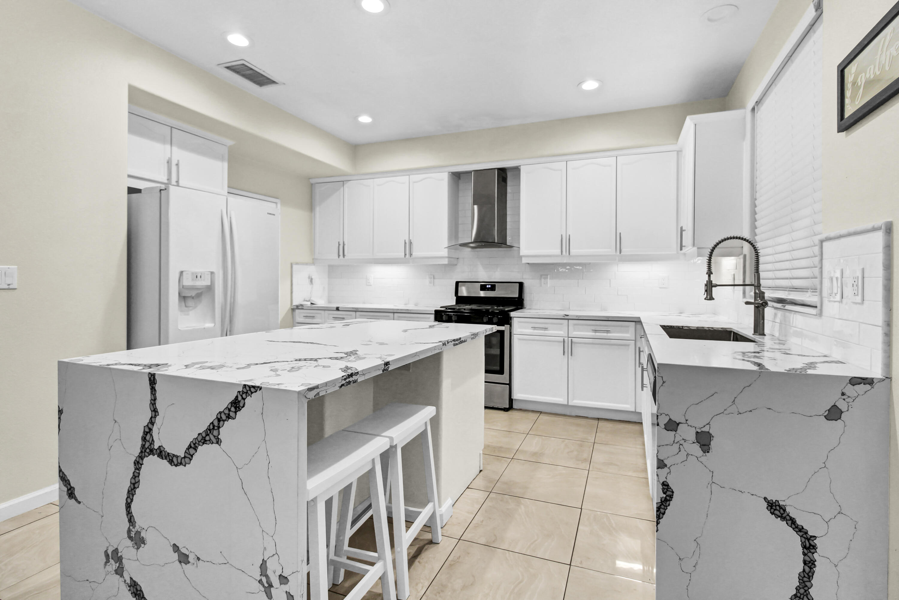 82949 Corte Lucia Indio, CA 92201 - Photo 4 of 36 a kitchen with a sink a stove a refrigerator and cabinets
