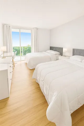 a large white bed in a large room