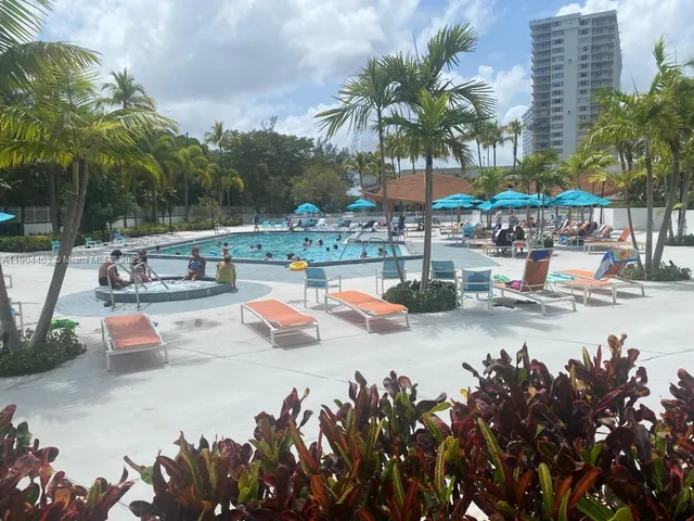 a view of a swimming pool and lounge chairs
