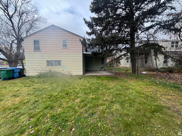 704 North 200 East Logan, UT 84321 - Photo 21 of 24 Back of property featuring a patio and a yard
