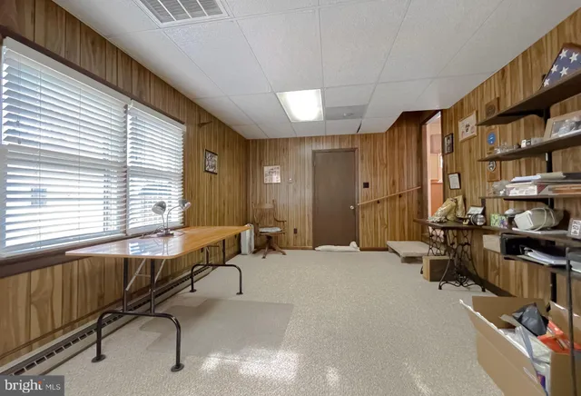 a kitchen with stainless steel appliances granite countertop a sink a stove a refrigerator a microwave oven with white cabinets and wooden floor