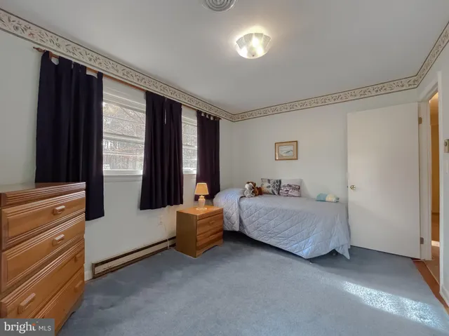 a bedroom with a bed and a view of bedroom