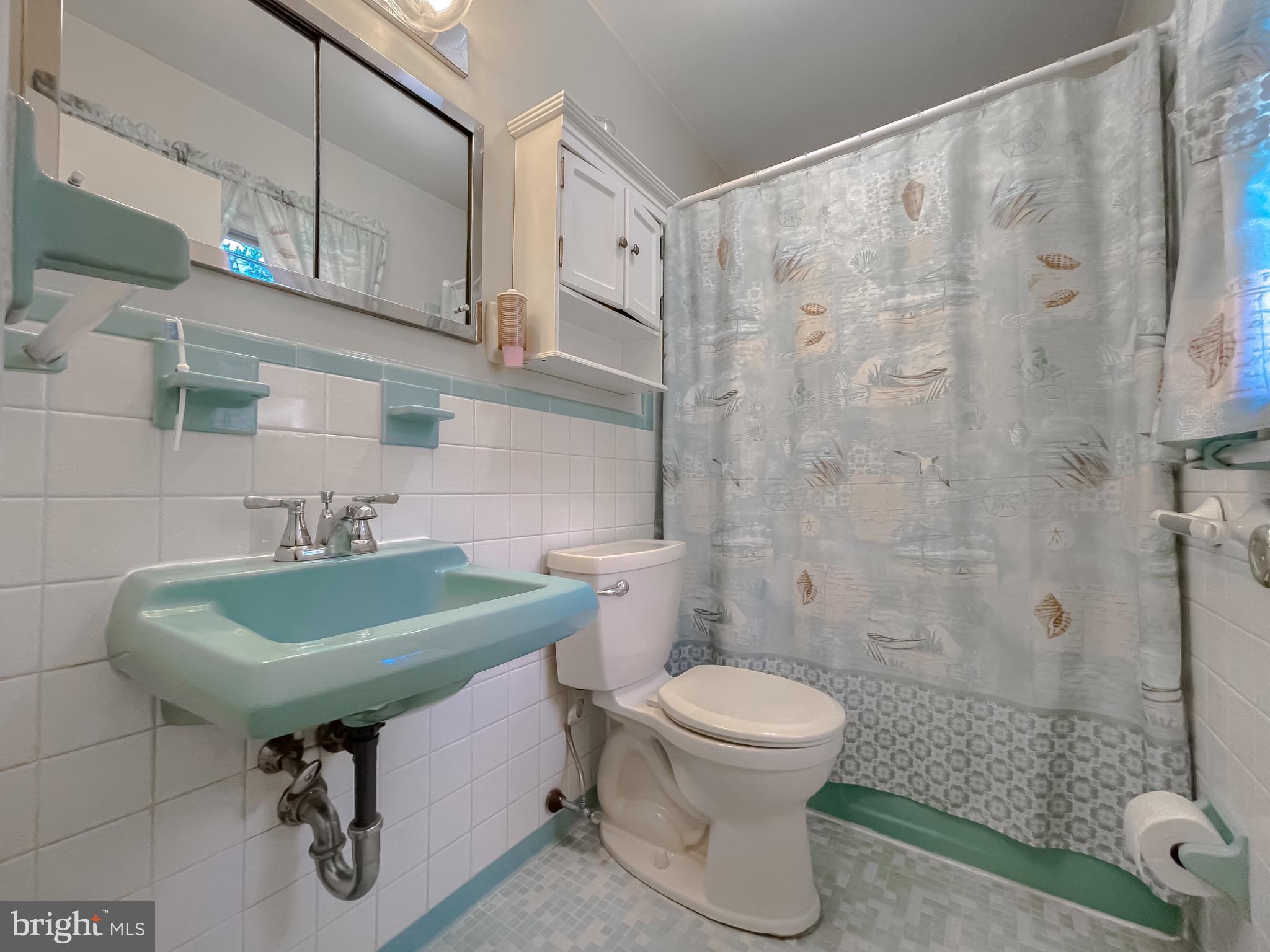 49078 Wynne Road Ridge, MD 20680 - Photo 33 of 57 Charming vintage bathroom with coastal accents.