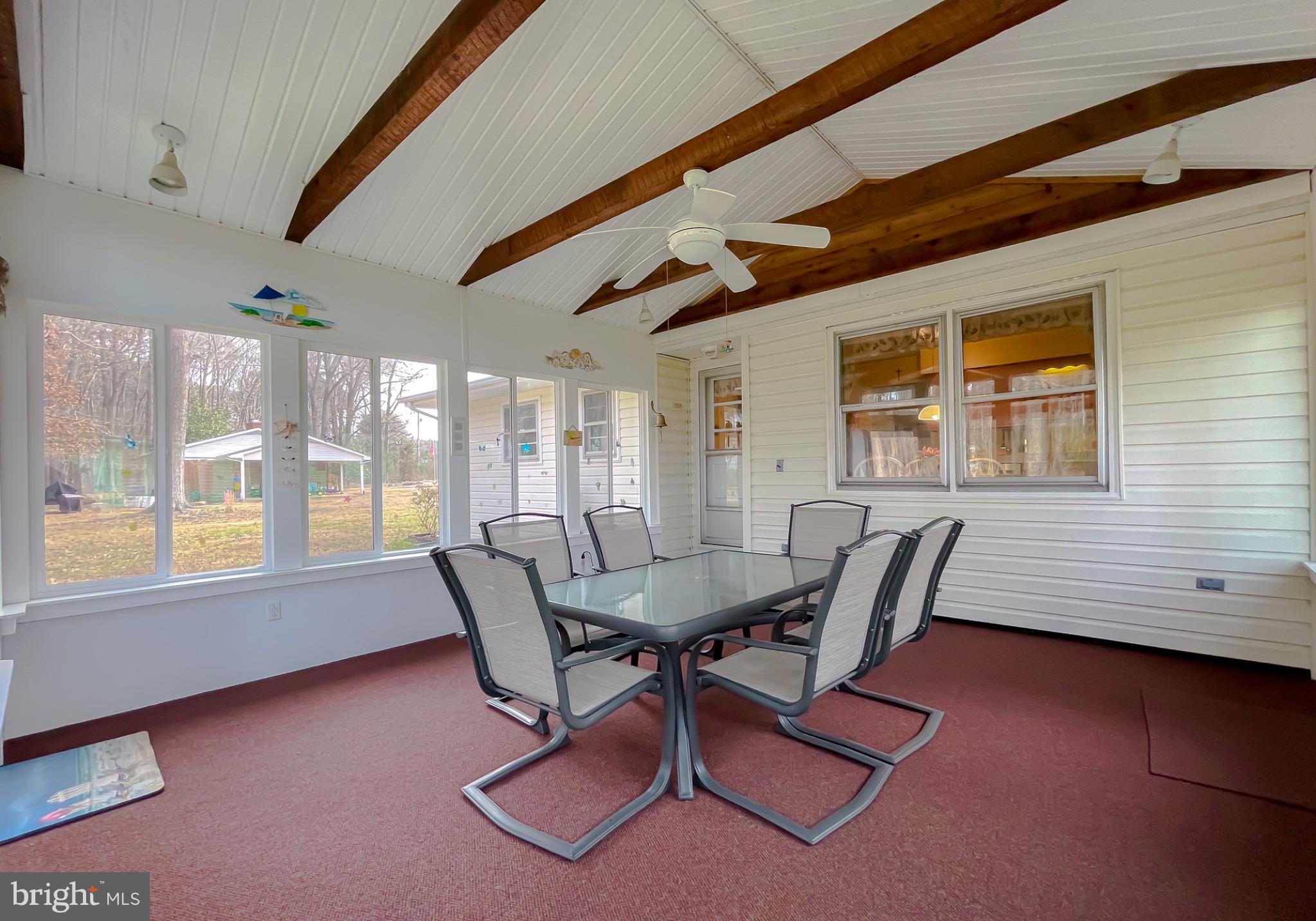 49078 Wynne Road Ridge, MD 20680 - Photo 38 of 57 Bright sunroom with charming wood beams.