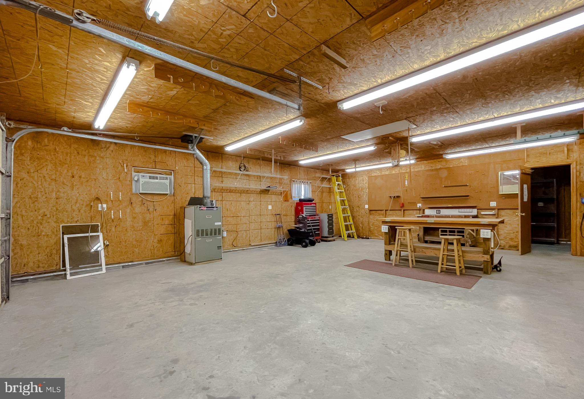 49078 Wynne Road Ridge, MD 20680 - Photo 52 of 57 Spacious workshop with ample storage options.