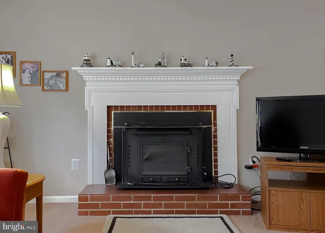 a living room with a fireplace and a flat screen tv
