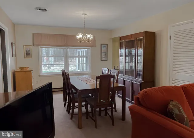 a view of a dining room with furniture and window