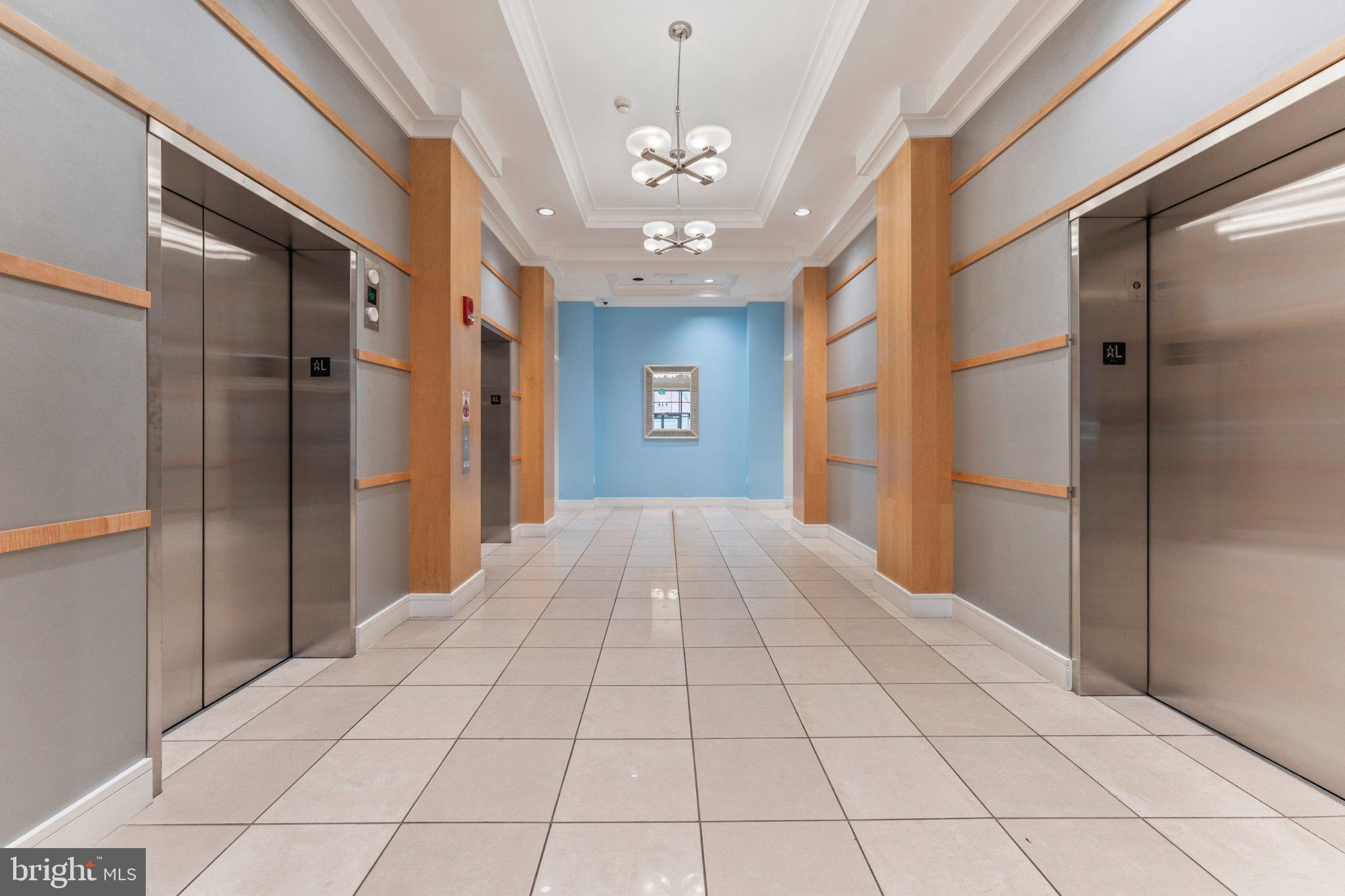 414 Water Street, Unit 1306 Baltimore, MD 21202 - Photo 8 of 29 Modern elevator lobby with sleek design.