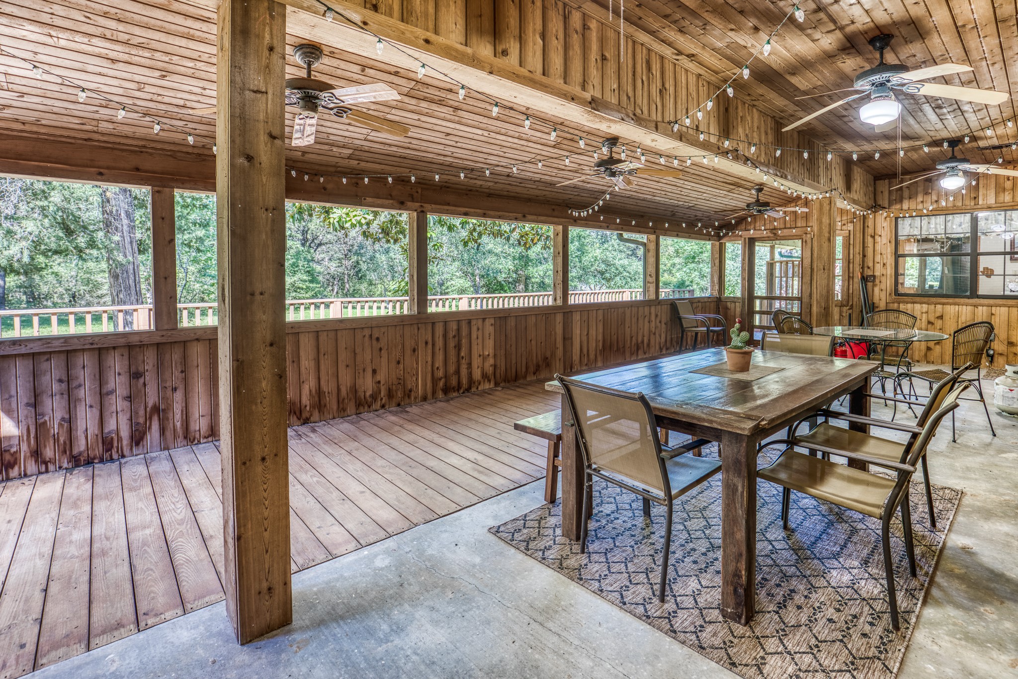 1017 Allen Road Cat Spring, TX 78933 - Photo 23 of 47 a view of a table and chairs in patio with wooden floor