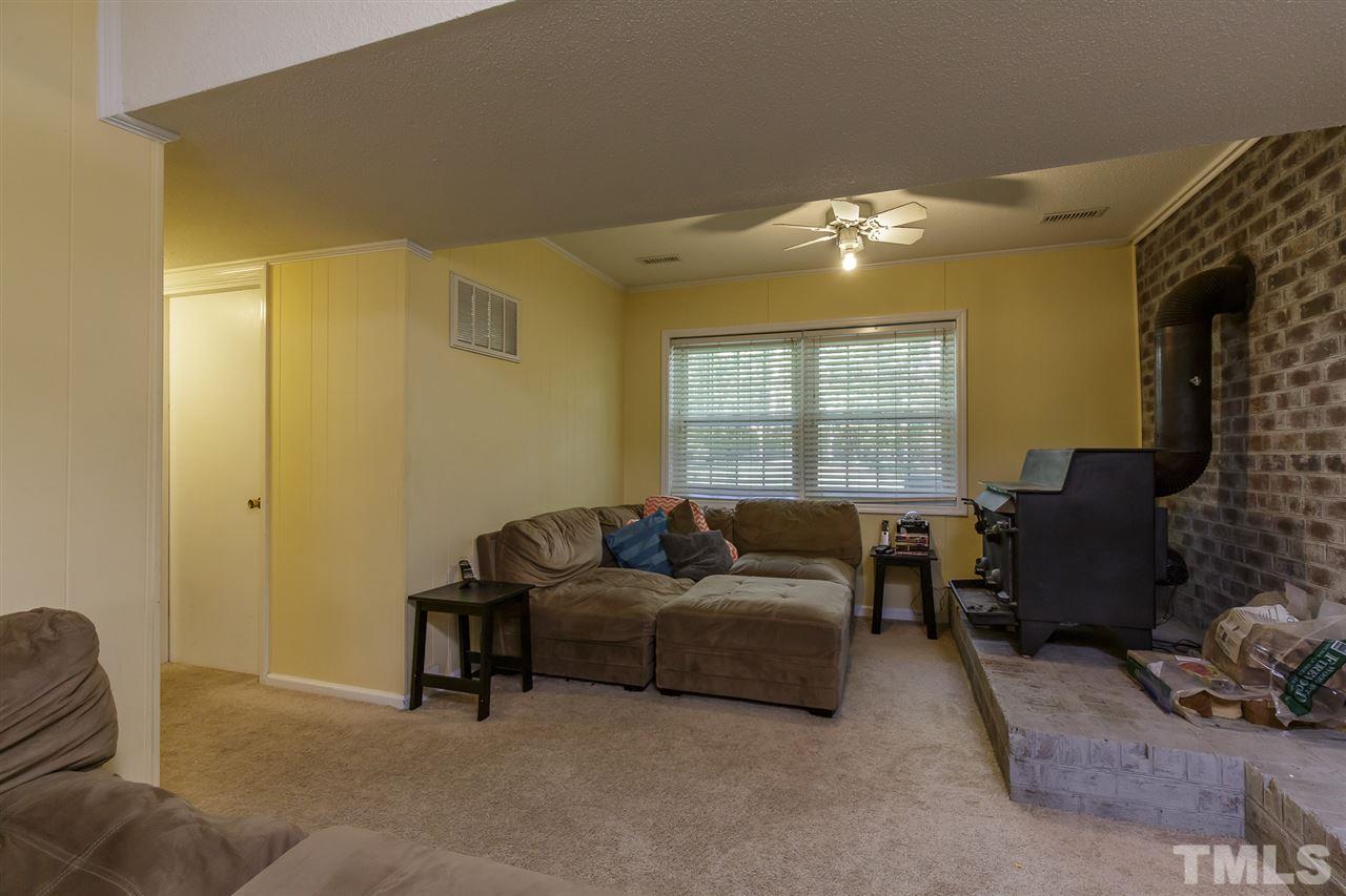 1901 Wellington Road Burlington, NC 27217 - Photo 19 of 24 Sitting area/den on the lower level of the home has wood burning fireplace. Could be used a rec room, man/woman cave or anything you can imagine!