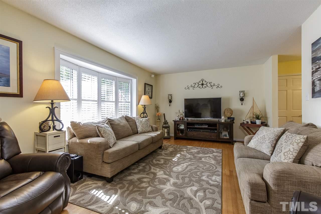 1901 Wellington Road Burlington, NC 27217 - Photo 4 of 24 Lovely living room with beautiful hardwood floors and a gorgeous bay window with plantation shutters