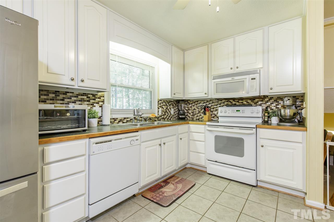 1901 Wellington Road Burlington, NC 27217 - Photo 8 of 24 Kitchen has ceramic tile floor, bright white cabinets, and lots of storage space