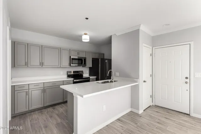 a kitchen that has a sink and a stove in it