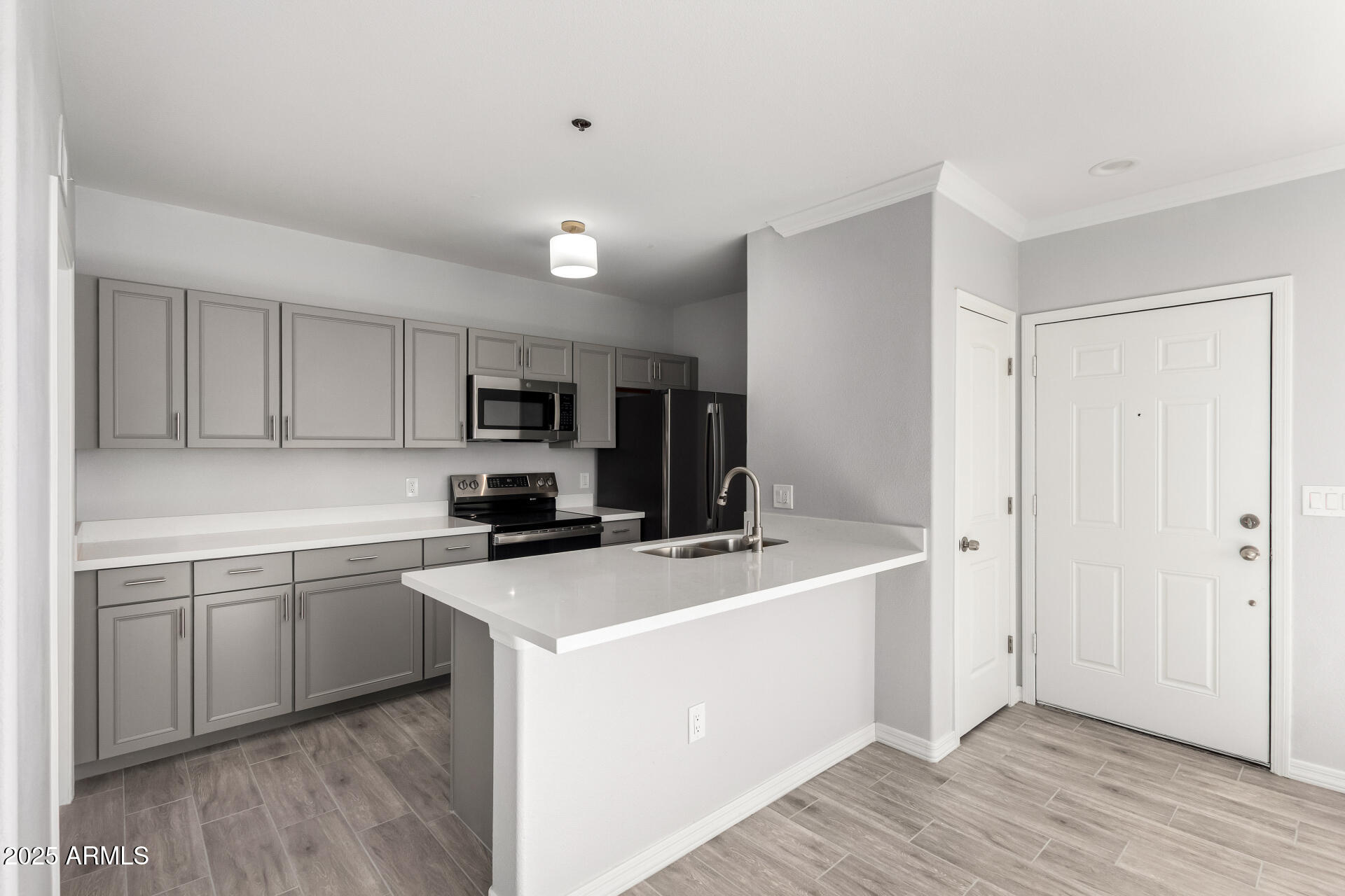 2134 East Broadway Road, Unit 1035 Tempe, AZ 85282 - Photo 12 of 31 a kitchen that has a sink and a stove in it