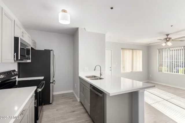 a kitchen with a sink stove and microwave