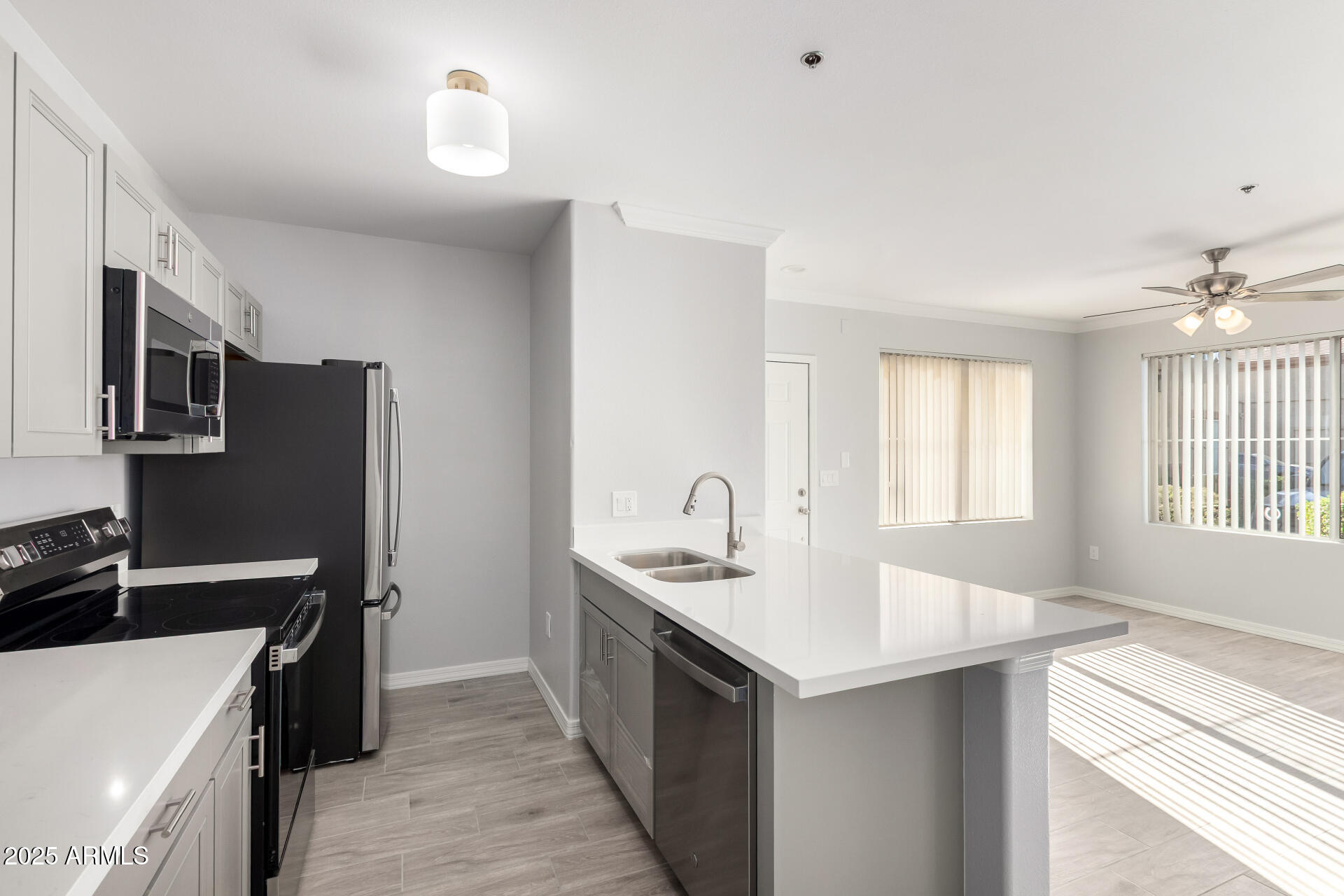 2134 East Broadway Road, Unit 1035 Tempe, AZ 85282 - Photo 14 of 31 a kitchen with a sink stove and microwave