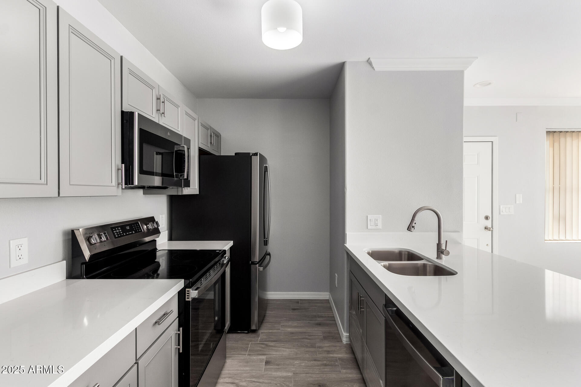 2134 East Broadway Road, Unit 1035 Tempe, AZ 85282 - Photo 15 of 31 a kitchen with stainless steel appliances granite countertop a sink stove and refrigerator