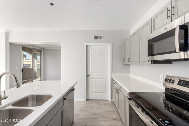 a kitchen with a sink and a stove top oven