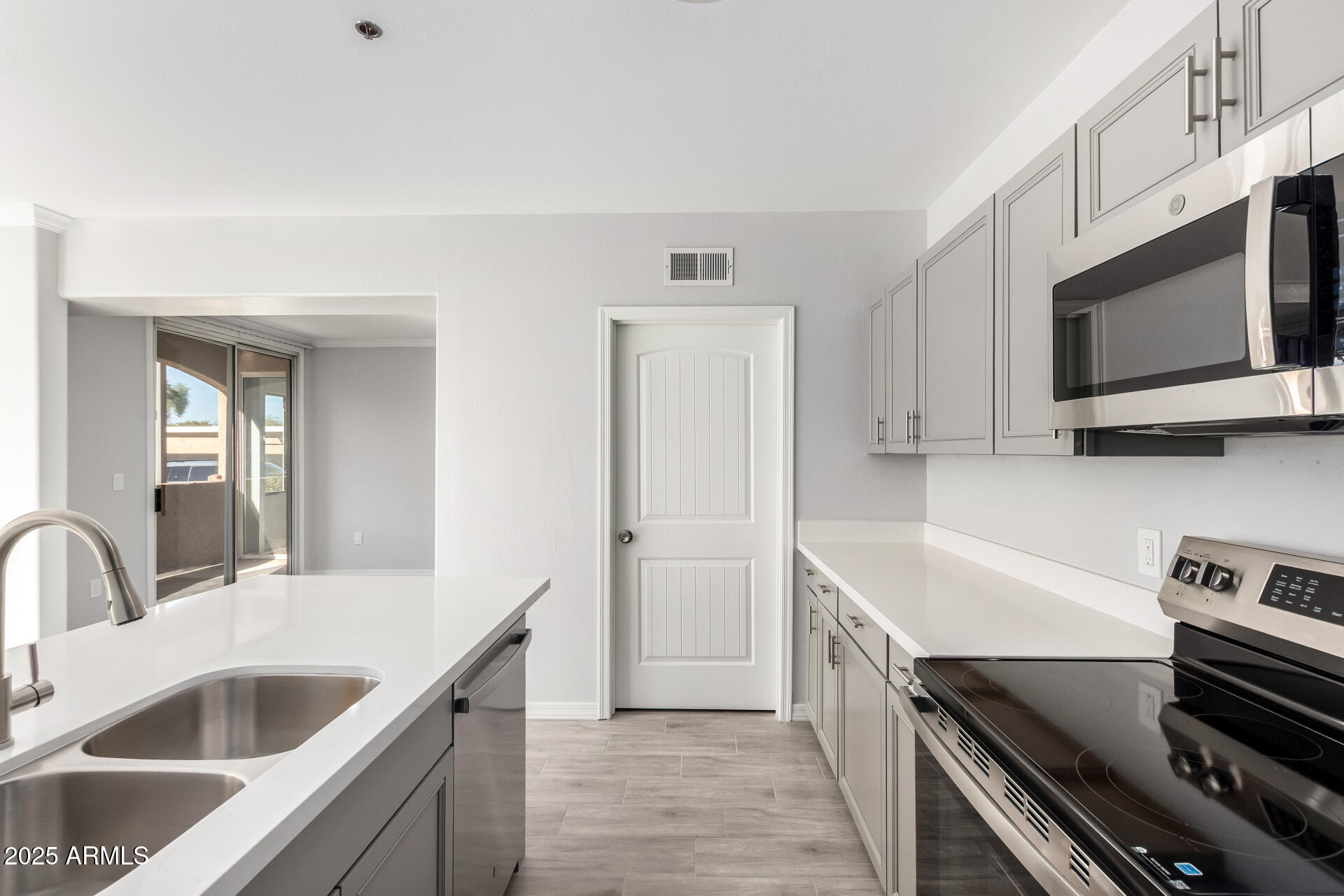2134 East Broadway Road, Unit 1035 Tempe, AZ 85282 - Photo 16 of 31 a kitchen with a sink and a stove top oven