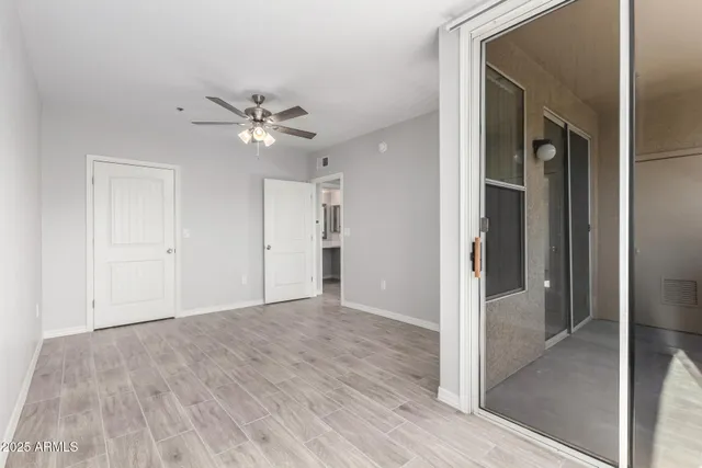 a view of an empty room with a ceiling fan